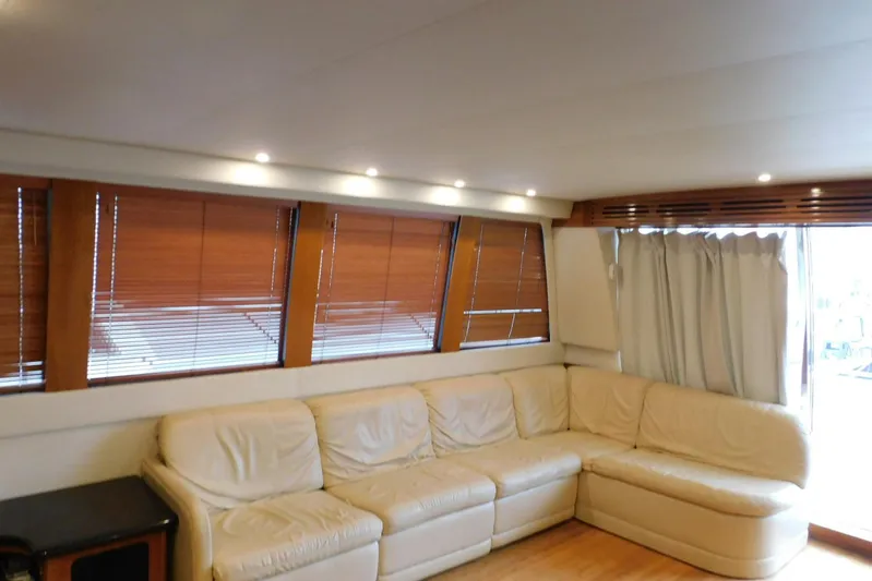 Waterdog Yacht Photos Pics Luxurious interior of 2002 Carver 570 Voyager Pilothouse with cream leather seating and wooden blinds.