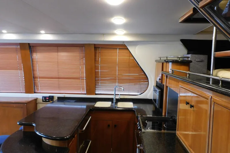 Waterdog Yacht Photos Pics Luxurious kitchen interior of 2002 Carver 570 Voyager Pilothouse yacht with wooden cabinets.