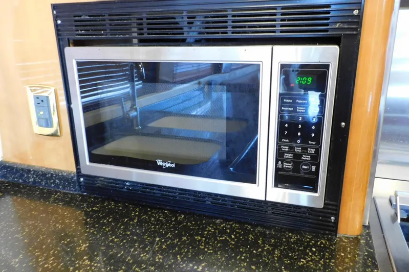 Waterdog Yacht Photos Pics Built-in Whirlpool microwave in 2002 Carver 570 Voyager Pilothouse kitchen.