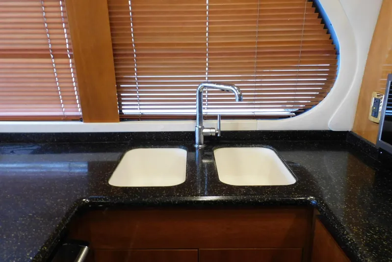 Waterdog Yacht Photos Pics Kitchen sink area in 2002 Carver 570 Voyager Pilothouse with dual basins and modern faucet.
