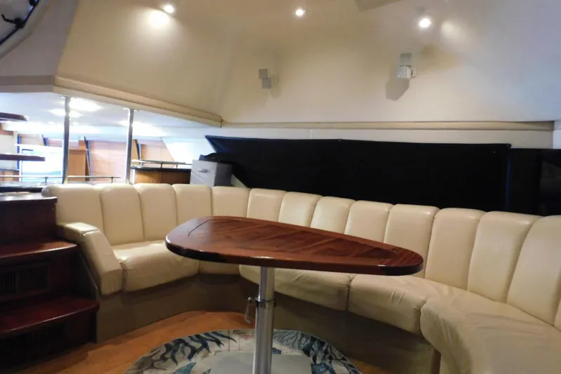 Waterdog Yacht Photos Pics Luxurious interior of 2002 Carver 570 Voyager Pilothouse with plush seating and elegant table.