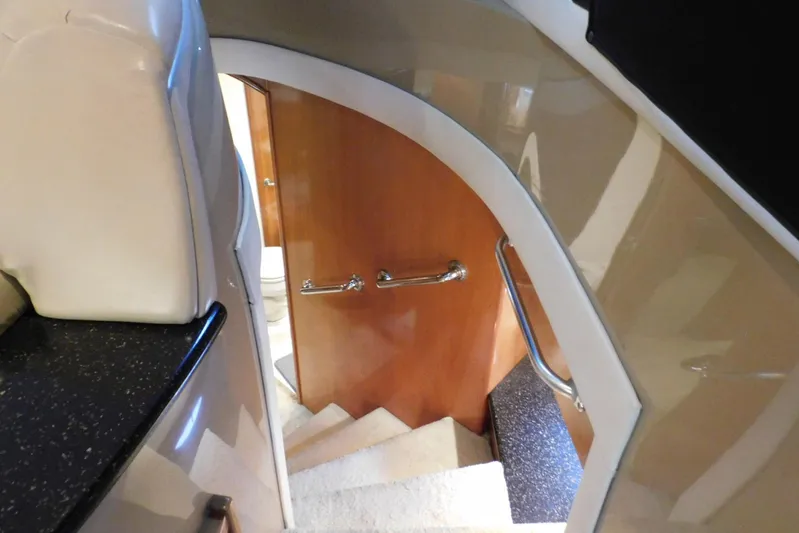 Waterdog Yacht Photos Pics Interior staircase of 2002 Carver 570 Voyager Pilothouse yacht with wooden door and handrails.