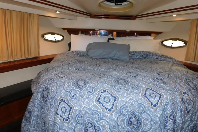 Waterdog Yacht Photos Pics Luxurious bedroom interior of 2002 Carver 570 Voyager Pilothouse yacht with patterned bedding.