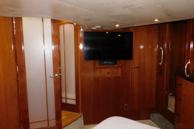 Waterdog Yacht Photos Pics Luxurious interior of 2002 Carver 570 Voyager Pilothouse with wood paneling and mounted TV.