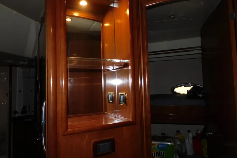 Waterdog Yacht Photos Pics Interior of 2002 Carver 570 Voyager Pilothouse with wooden cabinetry and cozy sleeping area.