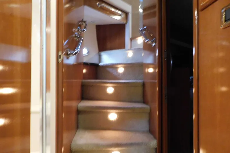 Waterdog Yacht Photos Pics Interior staircase of 2002 Carver 570 Voyager Pilothouse with carpeted steps and wooden paneling.