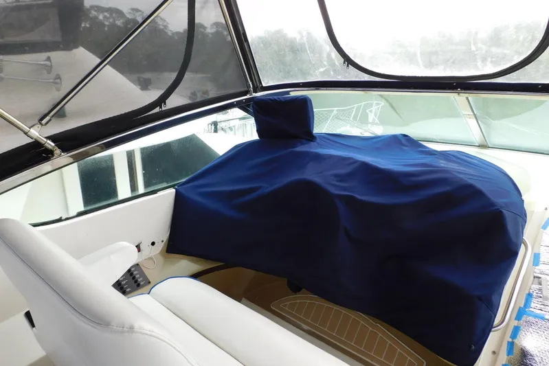 Waterdog Yacht Photos Pics 2002 Carver 570 Voyager Pilothouse helm covered with blue fabric.