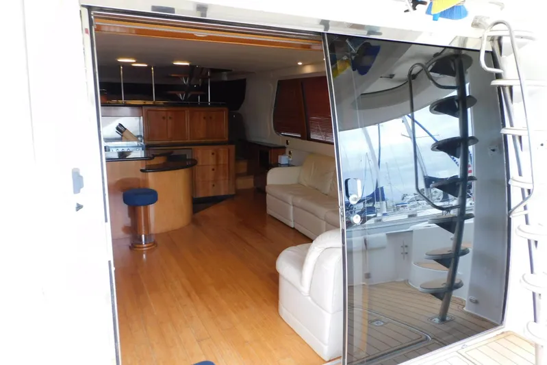 Waterdog Yacht Photos Pics Interior of 2002 Carver 570 Voyager Pilothouse yacht with modern furnishings and spiral staircase.