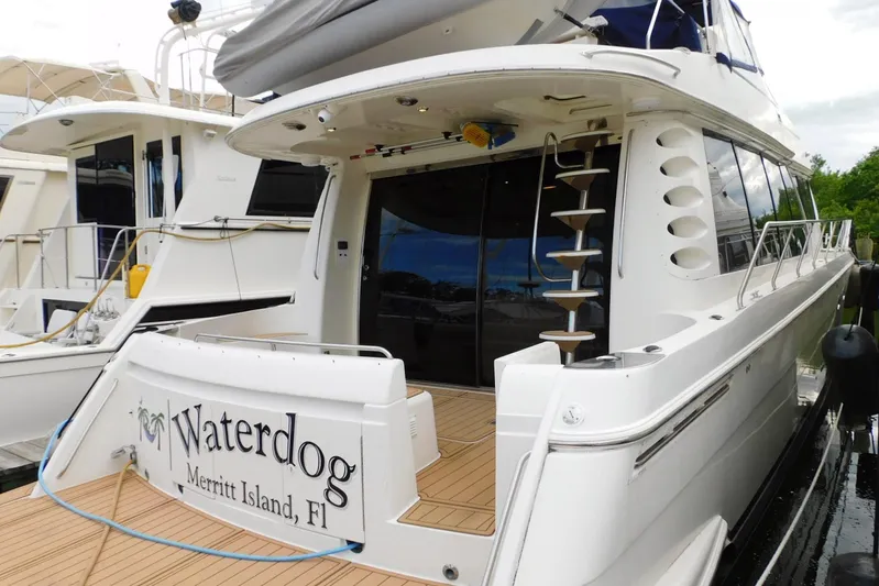 Waterdog Yacht Photos Pics 2002 Carver 570 Voyager Pilothouse yacht docked, featuring elegant design and spacious deck.