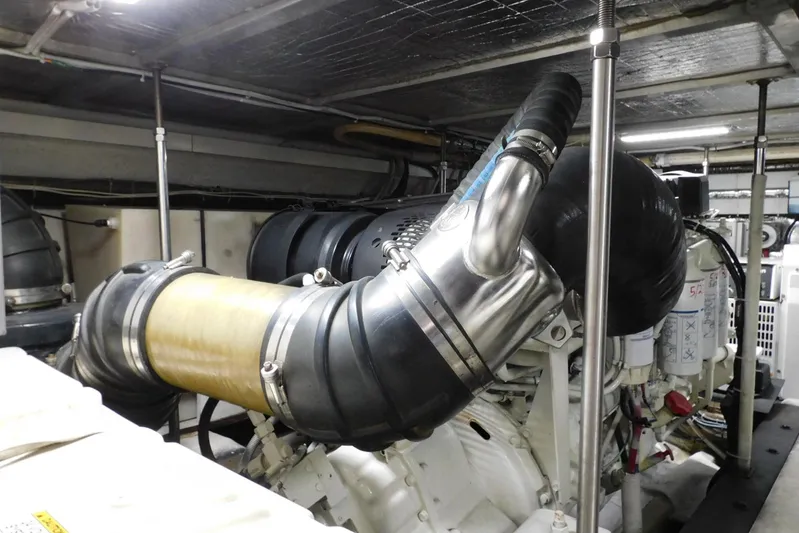 Waterdog Yacht Photos Pics Engine room of 2002 Carver 570 Voyager Pilothouse with visible exhaust system.