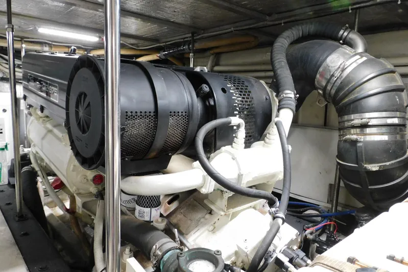 Waterdog Yacht Photos Pics Engine room of 2002 Carver 570 Voyager Pilothouse, showcasing mechanical components and piping.