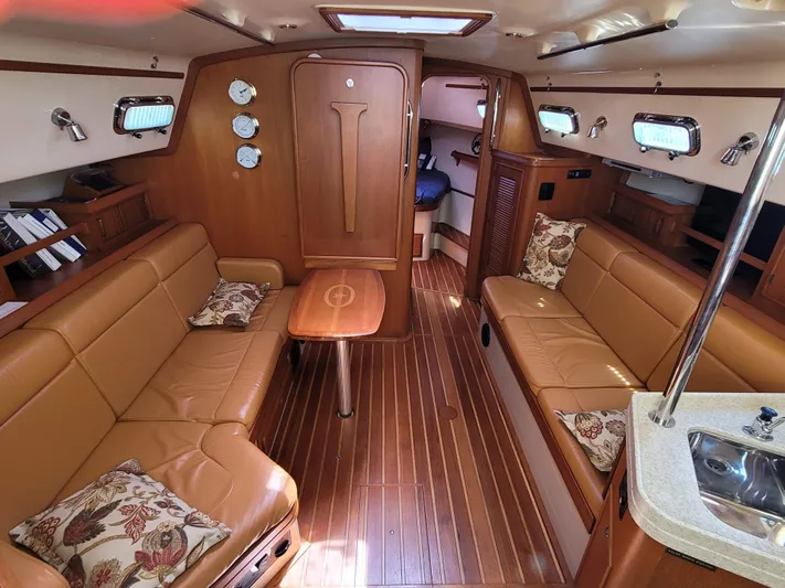 Mango Lll Yacht Photos Pics Interior of a 2006 Island Packet 370 sailboat with elegant wood finish and cozy seating.