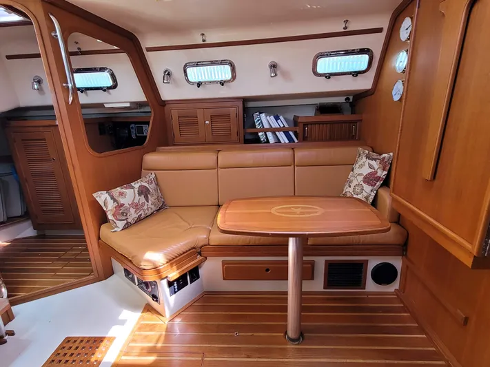 Mango Lll Yacht Photos Pics Interior of 2006 Island Packet 370 sailboat with wooden furnishings and cozy seating area.