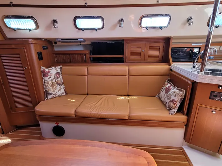 Mango Lll Yacht Photos Pics Interior of 2006 Island Packet 370 yacht with leather seating and floral cushions.