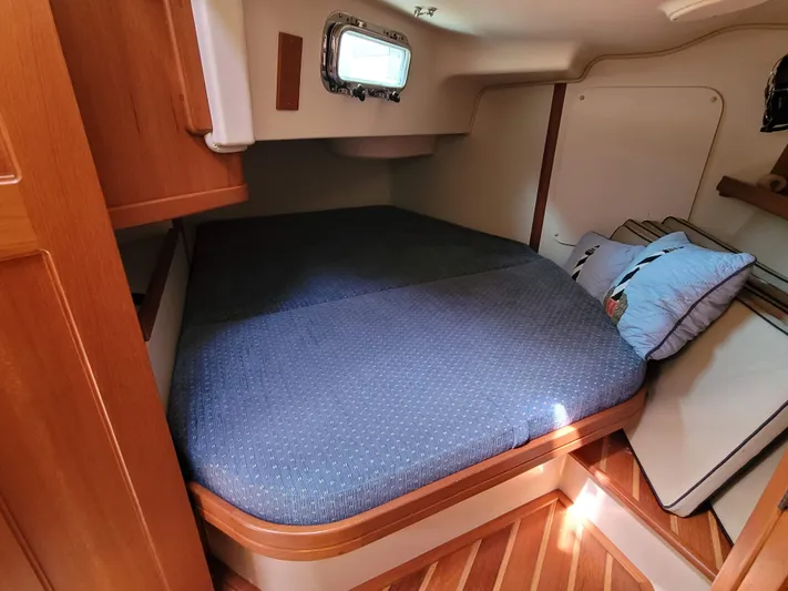 Mango Lll Yacht Photos Pics Cozy cabin interior of 2006 Island Packet 370 sailboat with blue bedding.