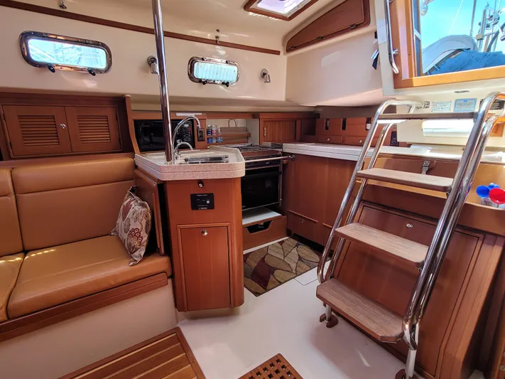 Mango Lll Yacht Photos Pics Interior of 2006 Island Packet 370 sailboat with kitchen and seating area.