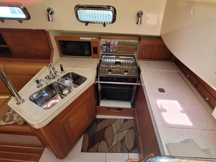 Mango Lll Yacht Photos Pics 2006 Island Packet 370 yacht kitchen with sink, stove, and microwave.