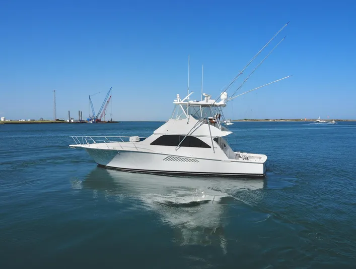  Yacht Photos Pics 2007 Viking Convertible yacht with mezzanine cruising on calm blue waters.
