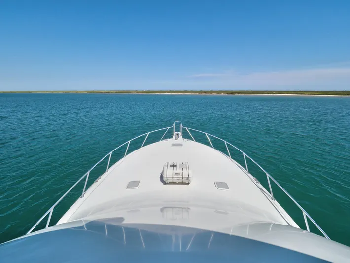  Yacht Photos Pics Bow view of 2007 Viking Convertible yacht on open water under clear blue sky.