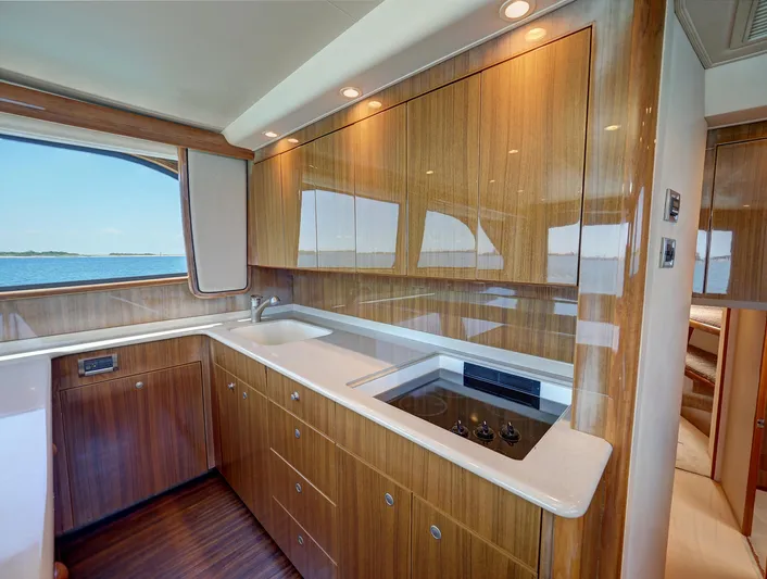  Yacht Photos Pics Luxurious 2007 Viking Convertible yacht kitchen with wood cabinetry and ocean view.