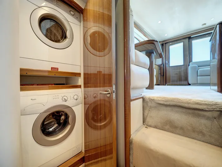  Yacht Photos Pics Laundry area in 2007 Viking Convertible yacht with mezzanine, featuring stacked washer and dryer.