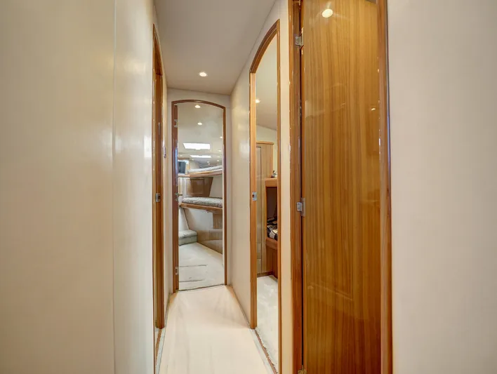  Yacht Photos Pics Interior hallway of 2007 Viking Convertible yacht with wooden doors and modern design.
