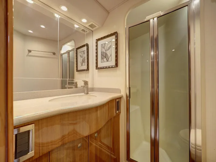  Yacht Photos Pics Luxurious bathroom in 2007 Viking Convertible yacht with wood cabinetry and glass shower.