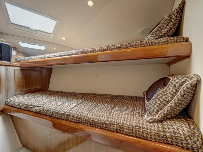  Yacht Photos Pics 2007 Viking Convertible yacht interior with mezzanine, featuring cozy bunk beds and elegant wood finish.