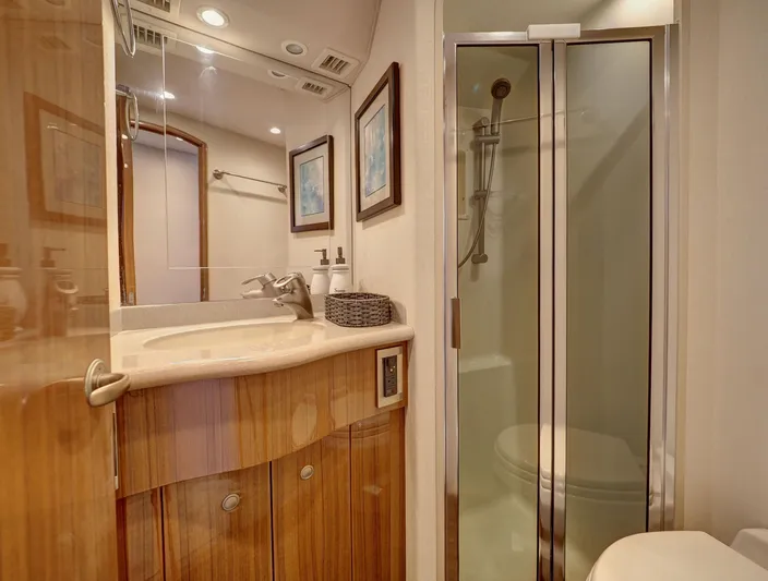  Yacht Photos Pics Luxurious bathroom in 2007 Viking Convertible yacht with shower and wooden cabinetry.