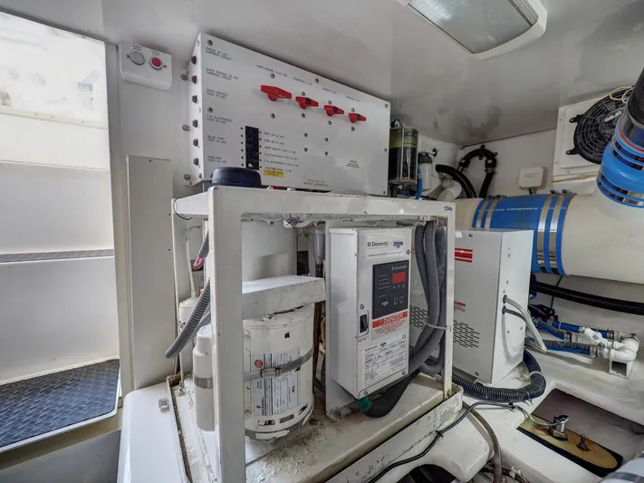  Yacht Photos Pics Engine room of 2007 Viking Convertible with mezzanine, featuring control panels and equipment.