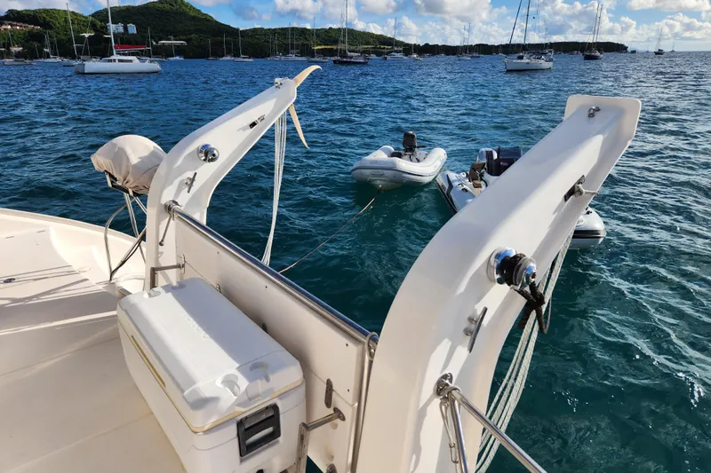 Leopard 46 Yacht Photos Pics Leopard 46 catamaran deck with dinghy, anchored in scenic bay, 2009 model.