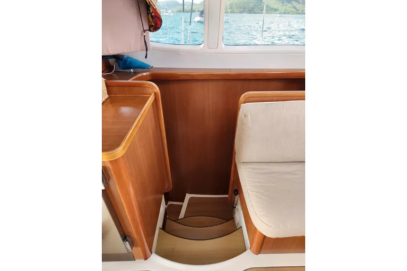 Leopard 46 Yacht Photos Pics Interior of 2009 Leopard 46 yacht with wooden cabinetry and cushioned seating.