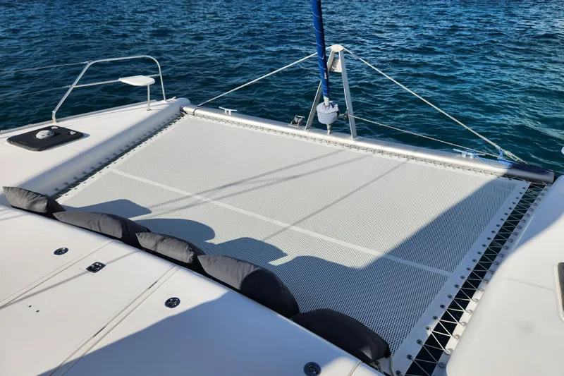 Leopard 46 Yacht Photos Pics 2009 Leopard 46 catamaran deck with netting over blue ocean water.