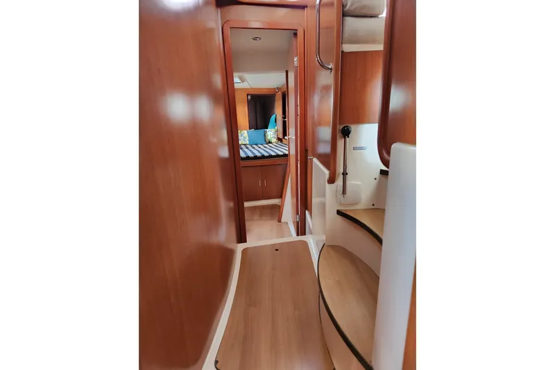 Leopard 46 Yacht Photos Pics Interior view of 2009 Leopard 46 yacht, featuring wooden finishes and a cozy cabin.