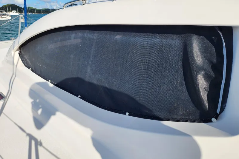 Leopard 46 Yacht Photos Pics 2009 Leopard 46 yacht window with sunshade, docked in a marina.