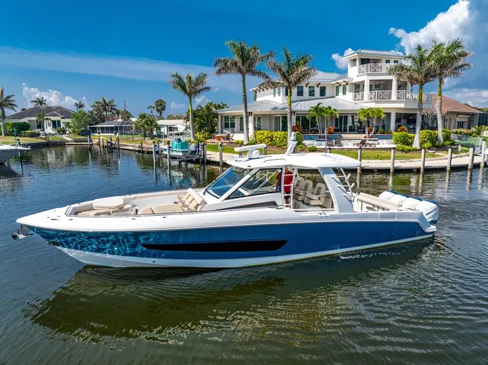 Jet Lag Yacht Photos Pics 2019 Boston Whaler 420 Outrage boat docked near luxury waterfront homes.