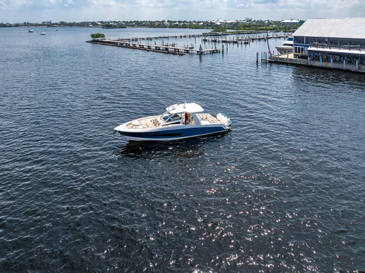 Jet Lag Yacht Photos Pics 2019 Boston Whaler 420 Outrage cruising near a marina on a sunny day.