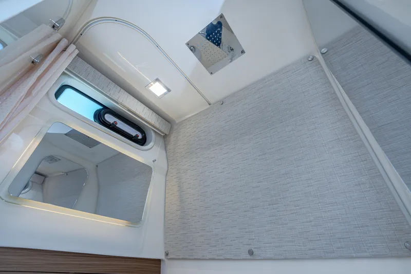 Jet Lag Yacht Photos Pics 2019 Boston Whaler 420 Outrage cabin interior with window, mirror, and modern lighting.