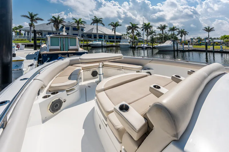 Jet Lag Yacht Photos Pics 2019 Boston Whaler 420 Outrage boat with luxurious seating at a marina under a sunny sky.