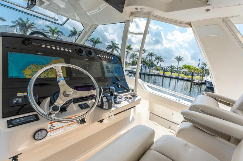Jet Lag Yacht Photos Pics 2019 Boston Whaler 420 Outrage helm with advanced navigation system and luxurious seating.