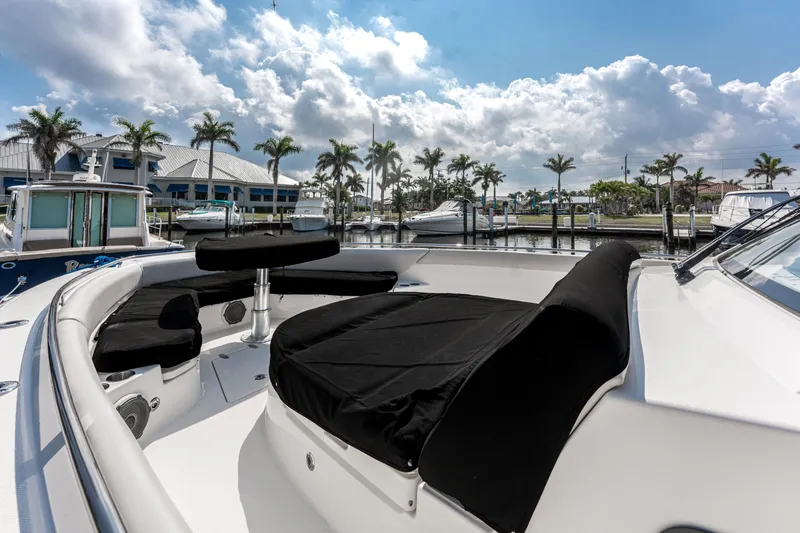 Jet Lag Yacht Photos Pics 2019 Boston Whaler 420 Outrage boat docked, featuring spacious seating and sleek design.