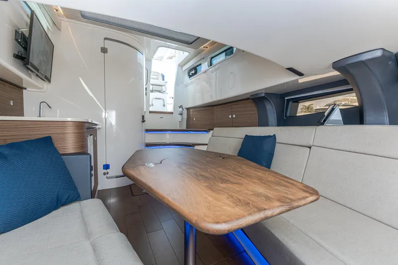 Jet Lag Yacht Photos Pics 2019 Boston Whaler 420 Outrage interior with modern seating and wooden table.