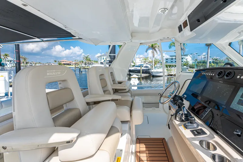 Jet Lag Yacht Photos Pics 2019 Boston Whaler 420 Outrage cockpit with luxurious seating and advanced navigation system.