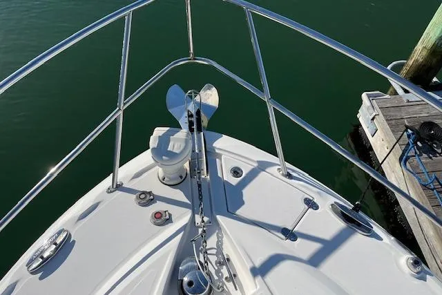  Yacht Photos Pics Bow of 2019 Monterey 355 Sport Yacht with anchor and railing, docked in calm water.