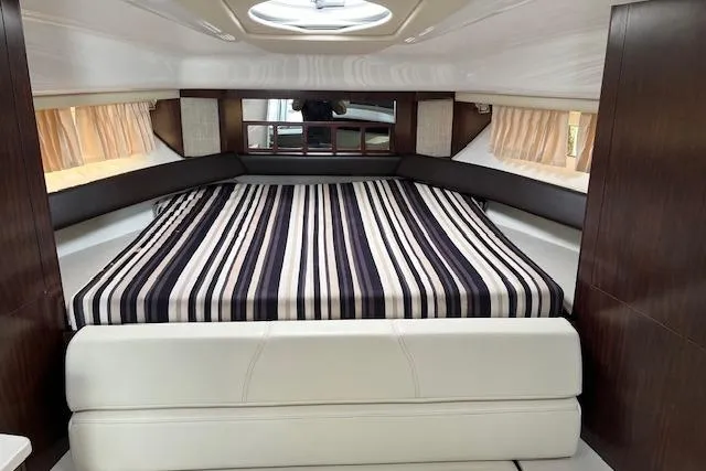  Yacht Photos Pics Interior cabin of 2019 Monterey 355 Sport Yacht with striped bedding and modern design.