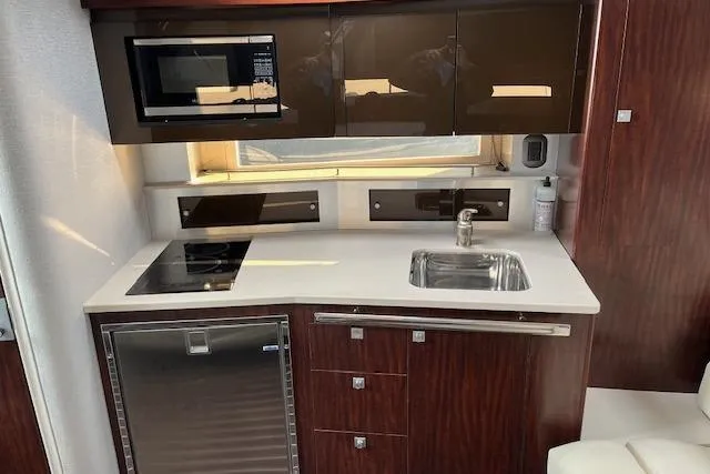  Yacht Photos Pics Modern kitchen in 2019 Monterey 355 Sport Yacht with microwave, sink, and fridge.