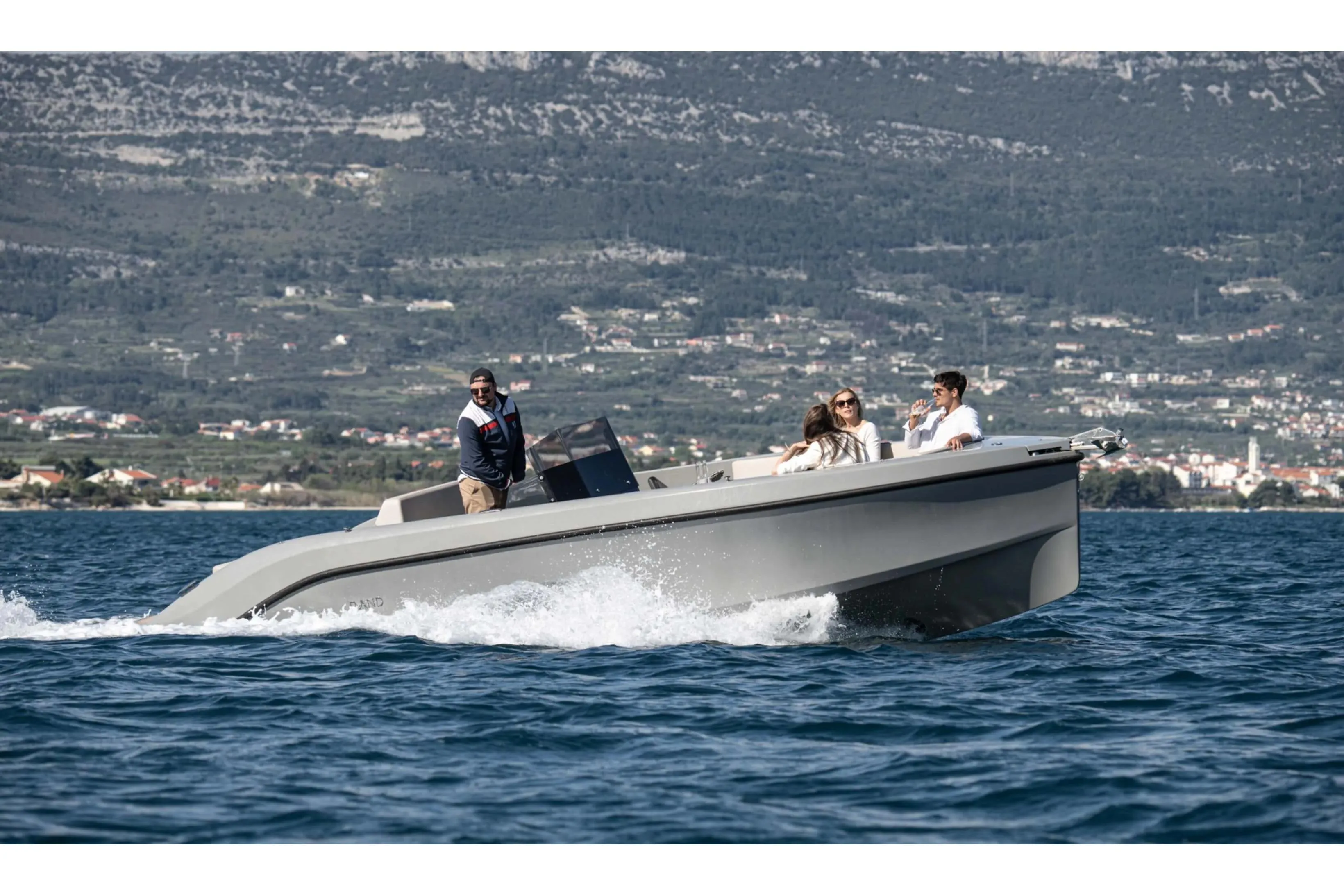 2023 Rand PLAY 24 boat cruising on scenic water with passengers enjoying the ride.