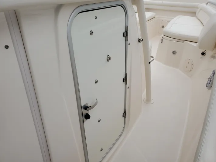  Yacht Photos Pics Interior of a 2017 Grady-White Canyon 336, featuring white door and seating.
