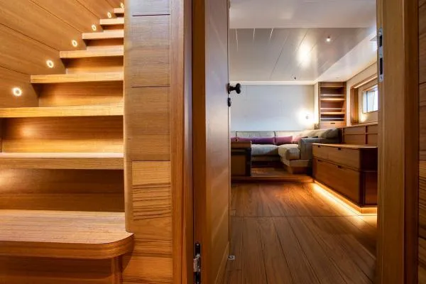 Canova Yacht Photos Pics Luxurious interior of 2019 Baltic Light Displacement Sailing Yacht with wooden finishes and cozy seating.