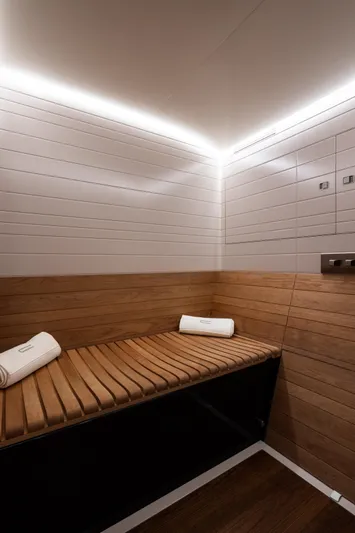 Canova Yacht Photos Pics Luxurious interior of 2019 Baltic Light Displacement Sailing Yacht with wooden seating and ambient lighting.